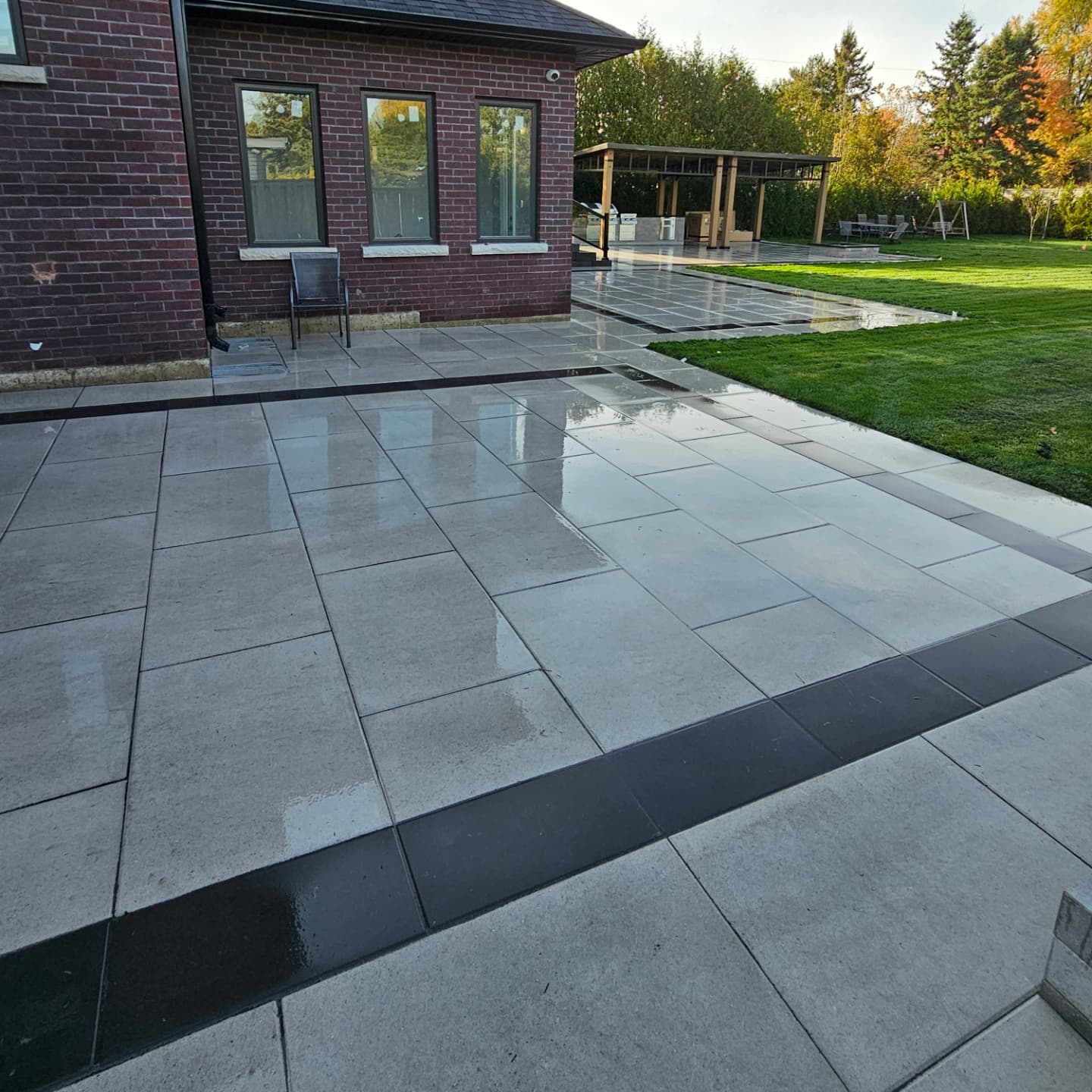 Interlocking paver patio and walkway beside a brick home in Durham Region